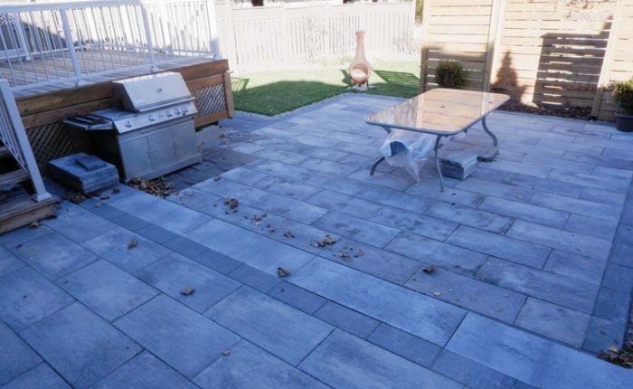 Patio made with Cassara slabs in grey mix color, with precast steps leading to a top landing. Slabs are 50mm thick and laid in a running bond pattern